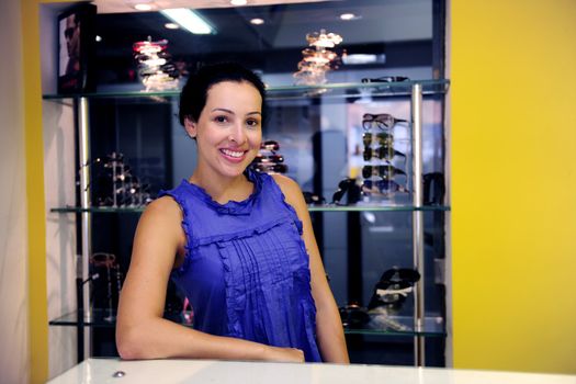 small business: portrait of an optometrist inside her store