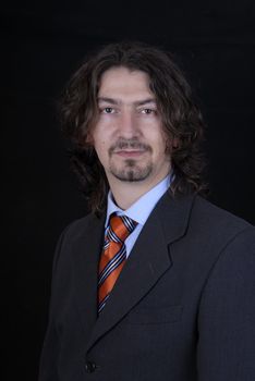 young business man portrait on black background