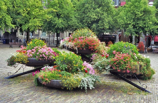 Multi-coloured spring flowers bloom in a square in Den Haag, the Netherlands.