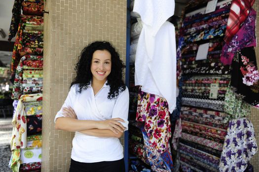 small business: happy owner of a fabric store