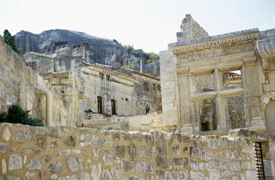 Ruins of an ancient Roman window can be seen beside modern construction and homes, Les Baux de Provence, France. 