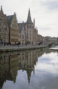 The buildings along the Graslei in Ghent, Belgium reflected in the water.