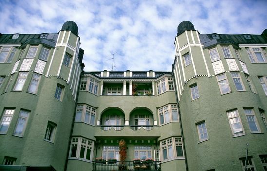 Green Stucco apartement building with iron balconies, Helsinki, Finland