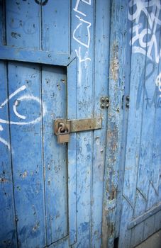 A lock on a blue warehouse door