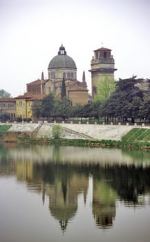 The Duomo of Verona Italy is reflected in the Adige River.