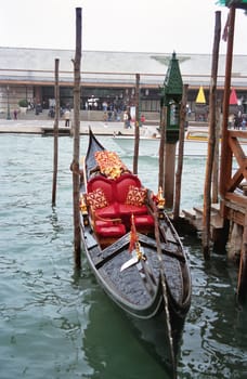 An ornate gondal awaits passengers on a Venice canal.