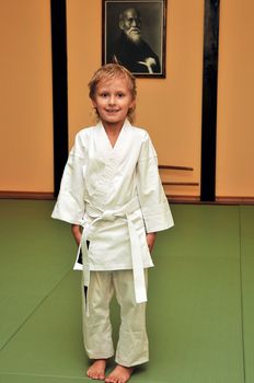 little boy has just got his first white belt in aikido