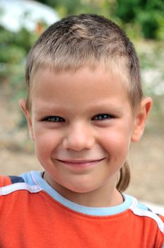 Happy smiling young boy looking in camera