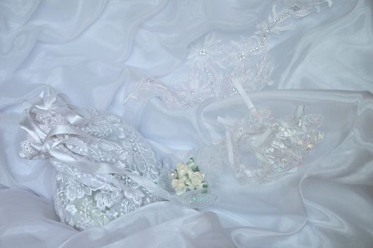  purse,  pin and  garter are laying on  dress 