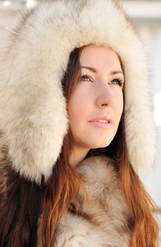 Swathed in furs brunette is looking up 