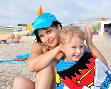 mother and son have a fun on the beach