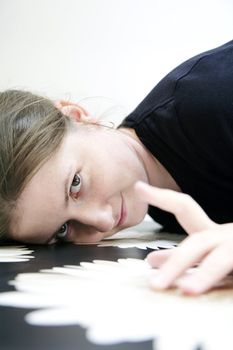 smiling woman draws attention, flower textured black surface