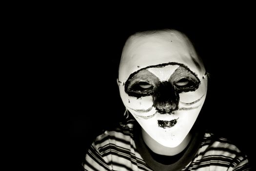 boy with a halloween mask, isolated on black