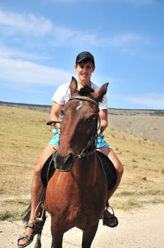 Man riding a horse, focus is on the horse's face 