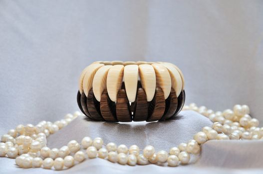 wooden bracelet with pearls on grey silk