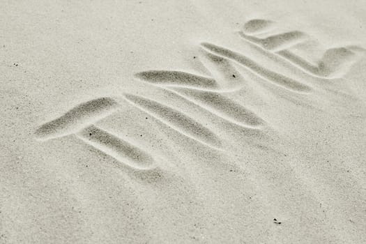 symbolic letters drawed in dune sand