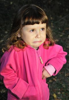  little girl with capricious expression on her face.

