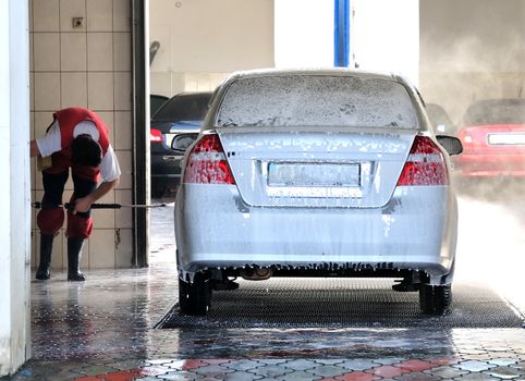 washerman washing Car at Car-wash service 
