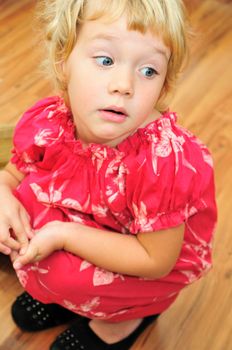 sitting funny little girl is wearing mother's shoes 