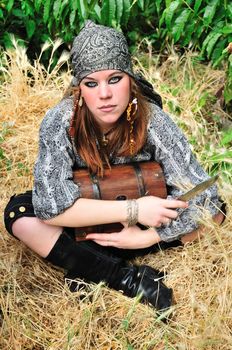 pirate girl is holding a trank and knife