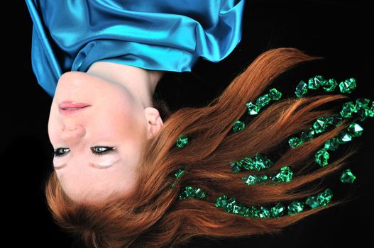 head of girl with natural red hair over black
