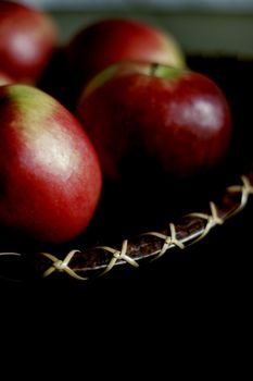 dark red apples on ornamental organic plate