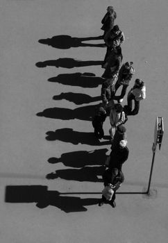 group of people with shadow silhouette waiting at the bus stop