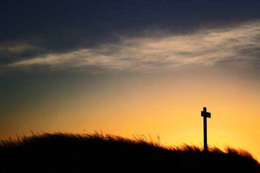 cross silhouette against the evening sun