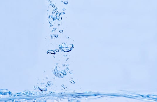 Water bubbles after a splash, with blue tint.