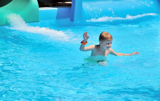 funny boy caming out of water after the water slide 