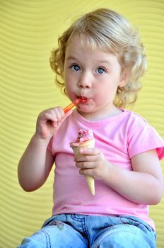 little girl outdoors eating huge ice cream cone
