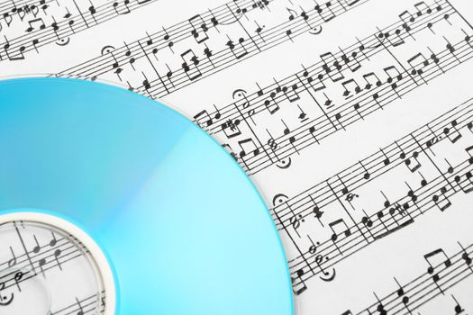 Blue CD or DVD and music notes. Digital music concept.