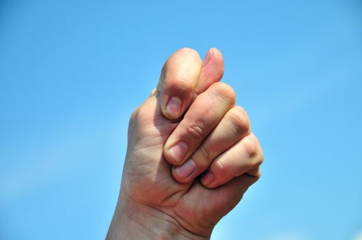 man's hand sticking 2 fingers up at someone