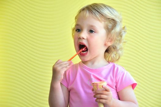little girl outdoors eating huge ice cream cone

