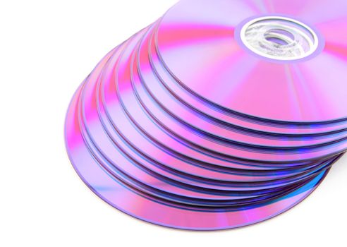 Stack of vibrant purple DVDs or CDs isolated on white background. No dust.
