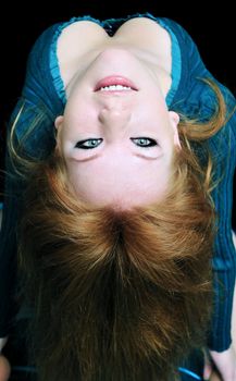 beautiful redheaded girl making a back- bend