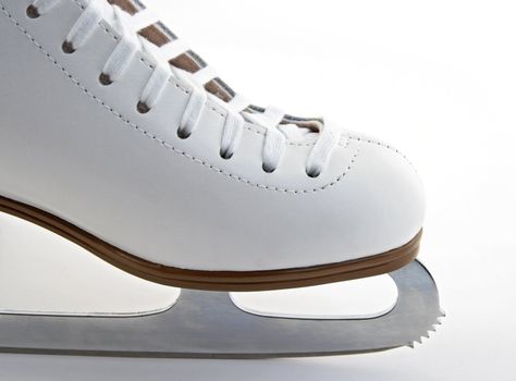 Toe and blade of a white elegant figure skate.