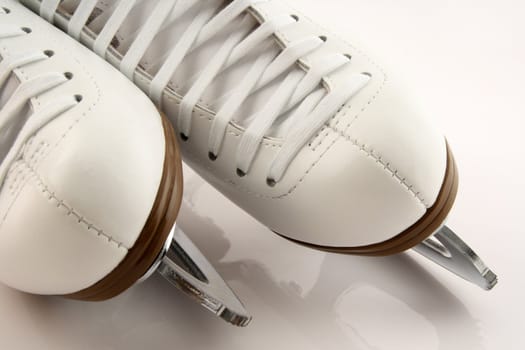 Closeup of elegant white figure skates.