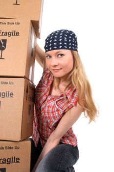 Portrait of a young woman holding a stack of cardboard boxes.
