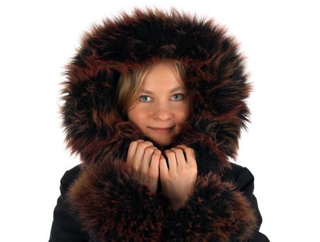 Portrait of smiling winter girl with a fur hood.