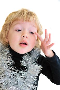 little girl feeling that she has a eyewinker in her eye, she is wearing christmas decoration