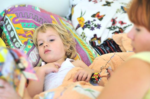 mother reading book for daughter before dream