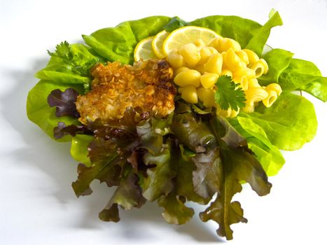 The image of macaroni of a fish and slices of a lemon close up