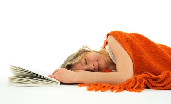 Cute girl fallen asleep with an open book.