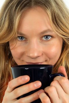 Portrait of charming young woman drinking tea.
