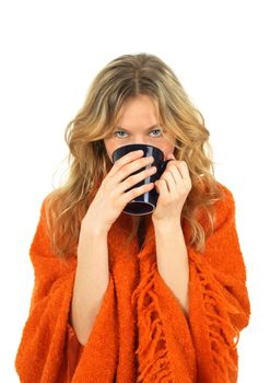 Cozy girl in orange, enjoying a big cup of tea.