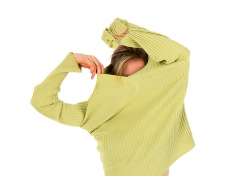Funny girl takes off a green stylish sweater.