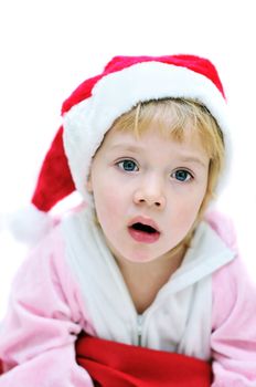 surprised little Santa girl over the white