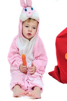 rabbit girl sitting near the bag and eating carrot
