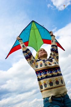 Young woman flying kite